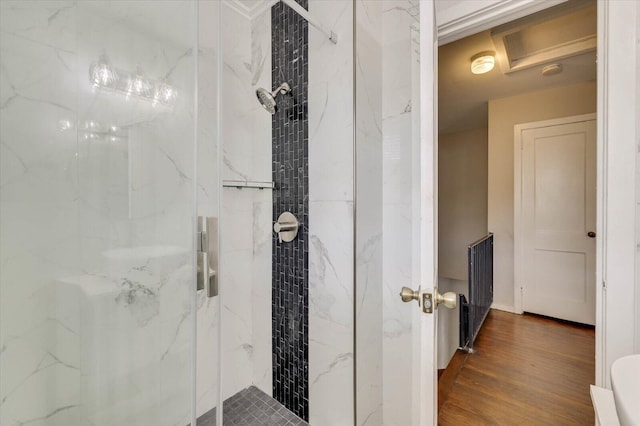 bathroom featuring an enclosed shower and wood-type flooring