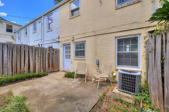 back of property featuring a patio area and central AC