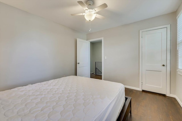 bedroom with ceiling fan and dark wood-type flooring