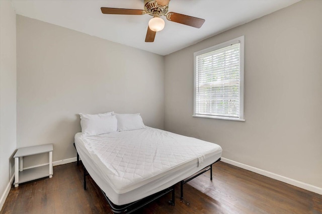 bedroom with ceiling fan and dark hardwood / wood-style floors