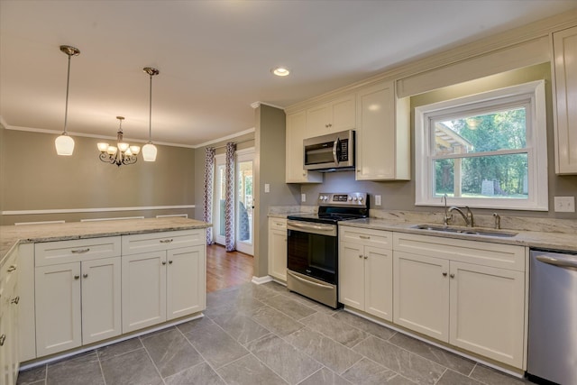 813 Hammond Dr, North Augusta, SC 29841 - kitchen with stainless steel appliances, a sink, ornamental molding, decorative light fixtures, and light stone counters