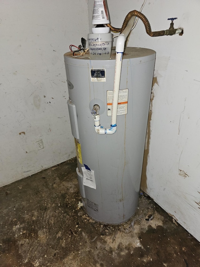 utility room featuring water heater