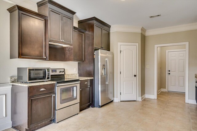 kitchen featuring appliances with stainless steel finishes, light stone counters, dark brown cabinets, and crown molding