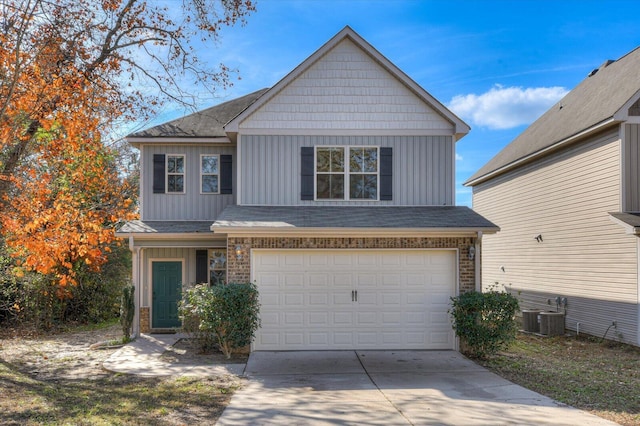 view of front of home featuring cooling unit and a garage