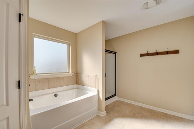 bathroom featuring separate shower and tub