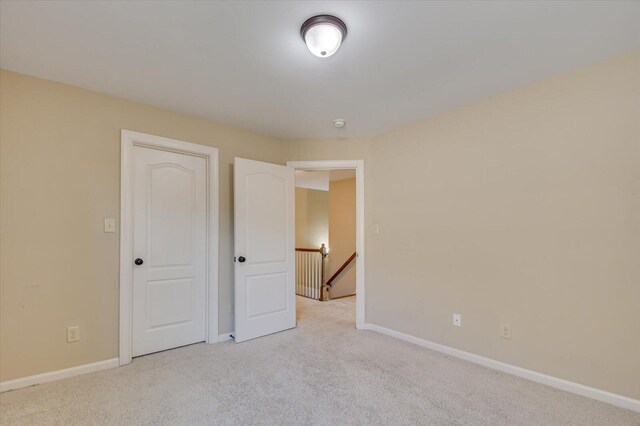 unfurnished bedroom with light carpet