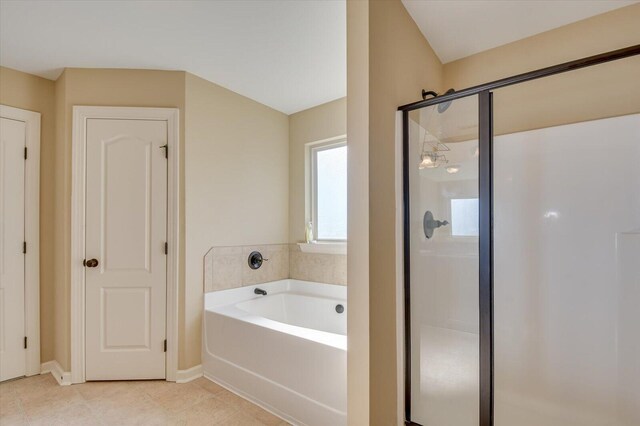 bathroom with tile patterned flooring and independent shower and bath