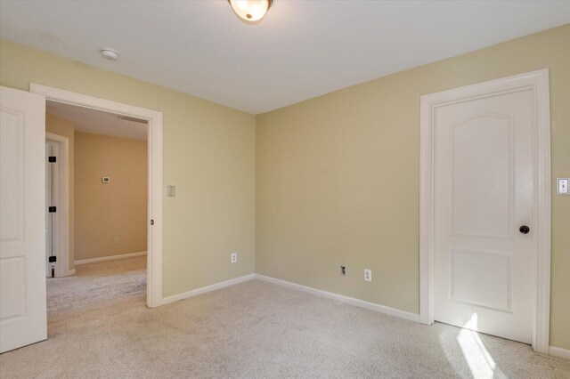 unfurnished room featuring light colored carpet