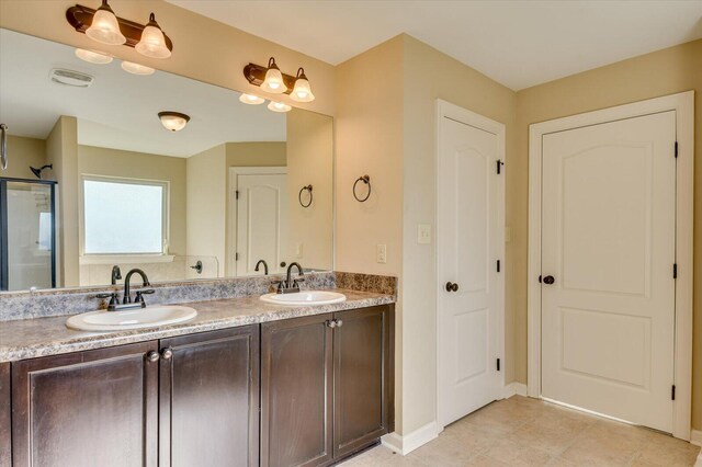 bathroom with vanity and a shower with door