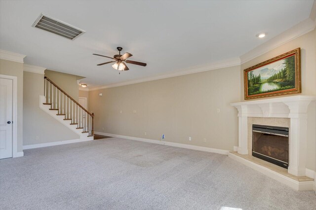 unfurnished living room featuring ceiling fan, light colored carpet, a premium fireplace, and ornamental molding