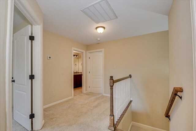 corridor featuring light colored carpet