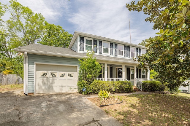 view of front of home with concrete driveway, a garage, and covered porch