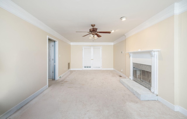 unfurnished living room with ornamental molding, ceiling fan, carpet flooring, and a fireplace