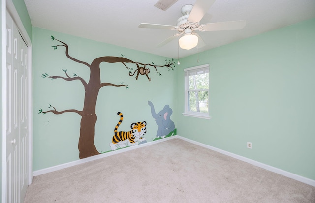 interior space featuring visible vents, baseboards, a ceiling fan, and carpet floors