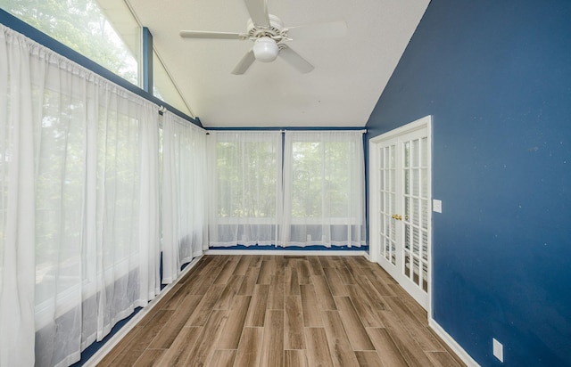unfurnished sunroom with french doors and ceiling fan