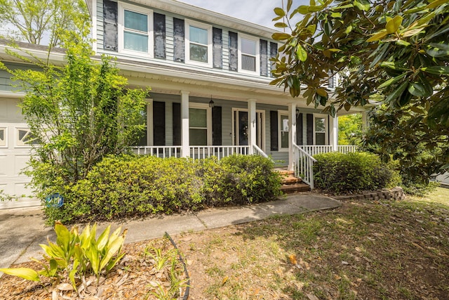 view of front of property featuring a porch and a garage