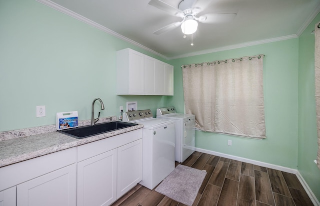clothes washing area with crown molding, dark wood finished floors, a sink, washer and dryer, and cabinet space