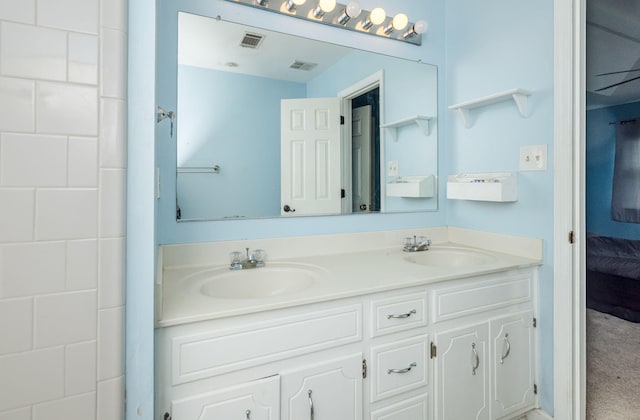 ensuite bathroom with a sink, visible vents, double vanity, and ensuite bath
