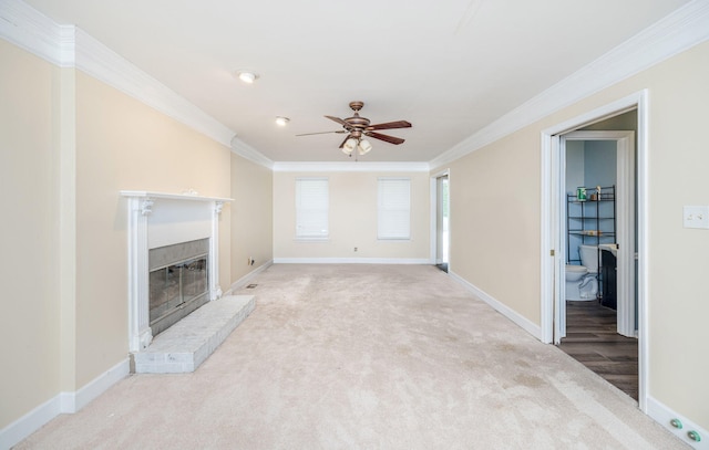 unfurnished living room with baseboards, ceiling fan, a fireplace, crown molding, and carpet floors