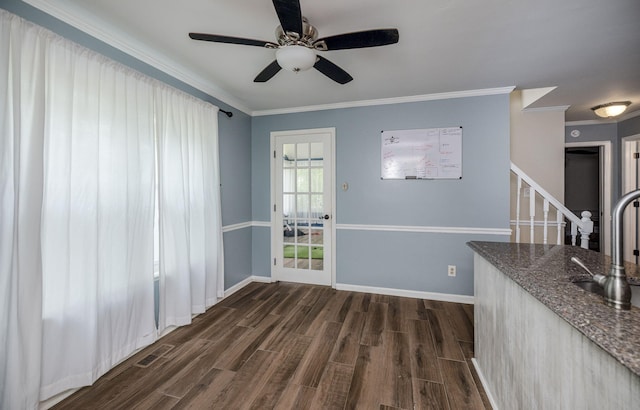 unfurnished dining area featuring dark wood-type flooring, ornamental molding, visible vents, stairway, and a sink