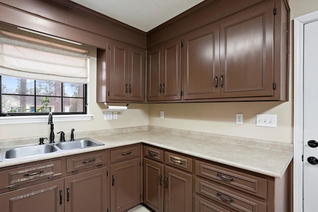 kitchen featuring a textured ceiling and sink