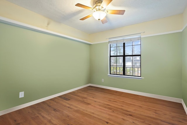 unfurnished room featuring ceiling fan, wood-type flooring, and a textured ceiling