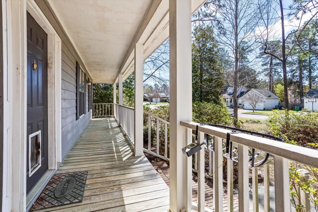 wooden terrace featuring covered porch