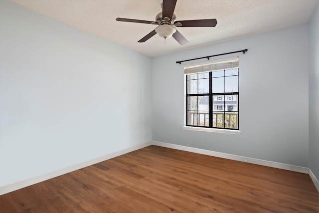 empty room with hardwood / wood-style floors, ceiling fan, and a textured ceiling