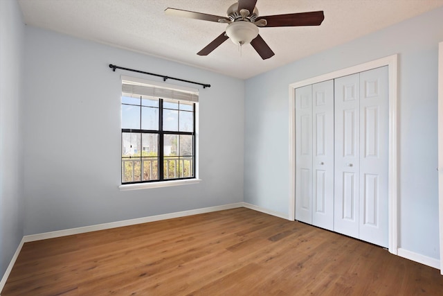 unfurnished bedroom with a closet, ceiling fan, and hardwood / wood-style flooring