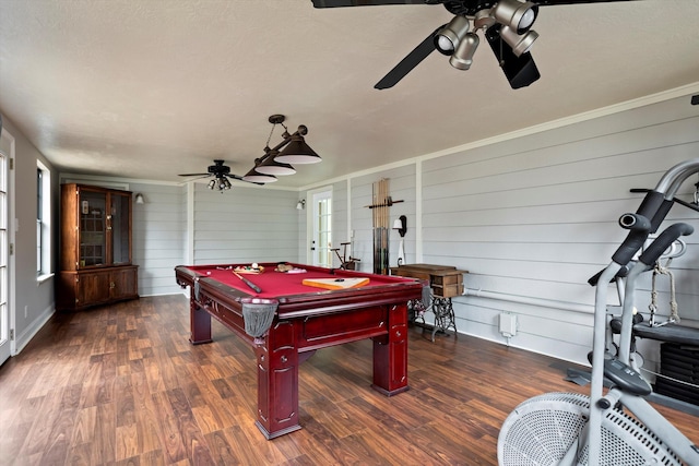 rec room with wooden walls, dark hardwood / wood-style flooring, crown molding, and pool table