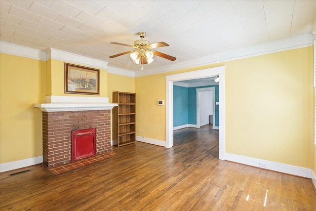 unfurnished living room with crown molding, a ceiling fan, baseboards, a brick fireplace, and wood finished floors