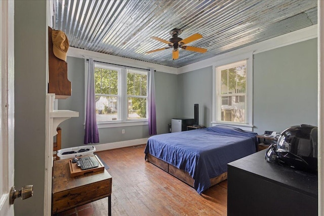 bedroom with hardwood / wood-style flooring, baseboards, wooden ceiling, and a ceiling fan