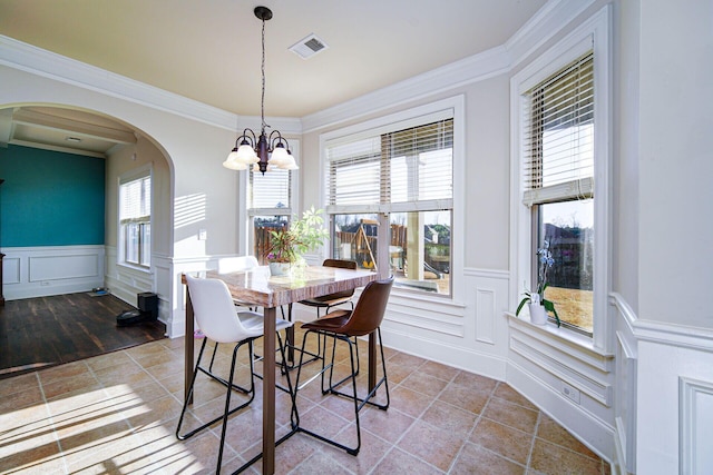 dining room featuring an inviting chandelier and ornamental molding