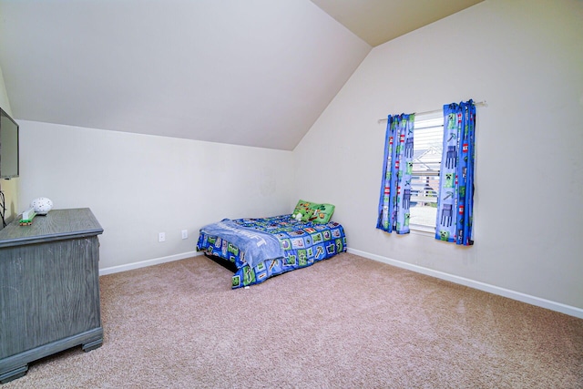 bedroom featuring lofted ceiling and carpet flooring