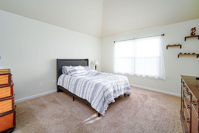 bedroom featuring light colored carpet and high vaulted ceiling