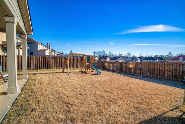 view of playground with a lawn