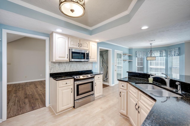 4610 Mulberry Creek Dr, Evans, GA 30809 - kitchen with appliances with stainless steel finishes, ornamental molding, backsplash, light wood-style floors, and dark stone counters