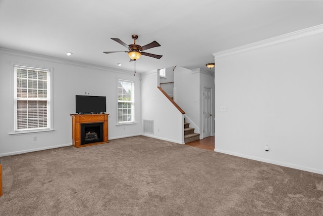 4942 Marble Dr, Evans, GA 30809 - unfurnished living room featuring visible vents, crown molding, ceiling fan, stairway, and carpet flooring