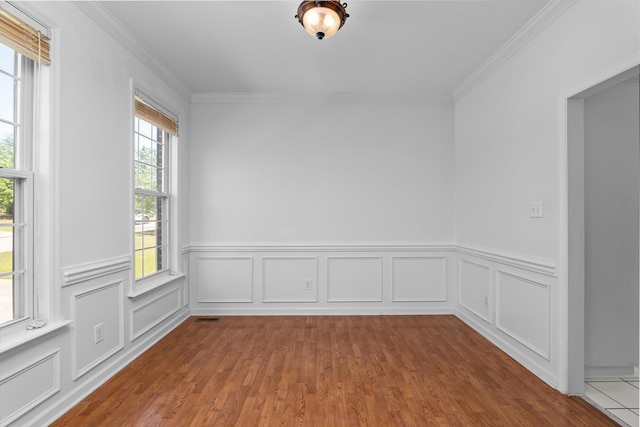 4942 Marble Dr, Evans, GA 30809 - unfurnished room with crown molding, wood finished floors, visible vents, and a wainscoted wall
