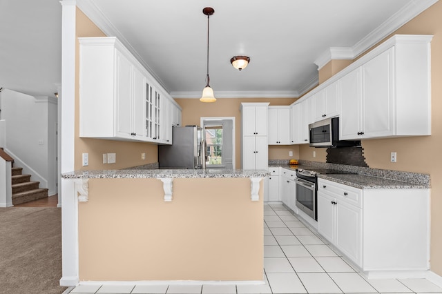 4942 Marble Dr, Evans, GA 30809 - kitchen with white cabinets, a peninsula, glass insert cabinets, a breakfast bar, and stainless steel appliances