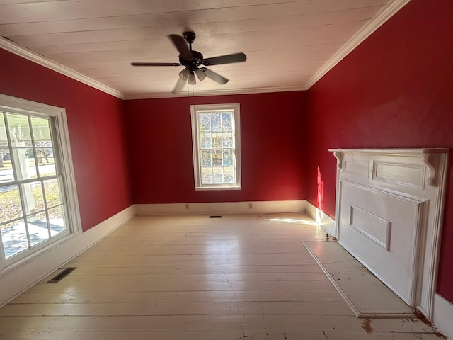 spare room featuring light wood-type flooring, ornamental molding, and a wealth of natural light