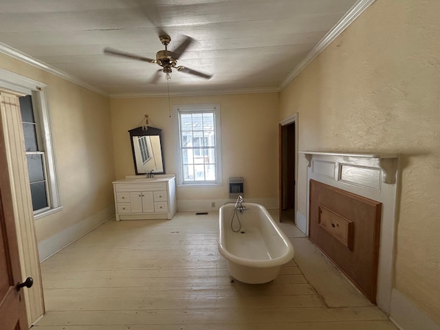 bathroom featuring ornamental molding, a bathtub, vanity, and hardwood / wood-style flooring