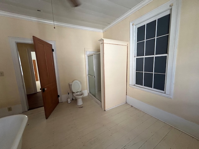 interior space with toilet, ornamental molding, and plus walk in shower