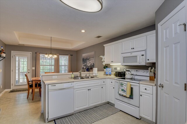 240 Full Circle Dr, Evans, GA 30809 - kitchen featuring white appliances, a peninsula, white cabinetry, a chandelier, and light countertops