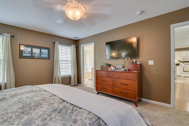 240 Full Circle Dr, Evans, GA 30809 - bedroom with light colored carpet, ensuite bathroom, and a ceiling fan