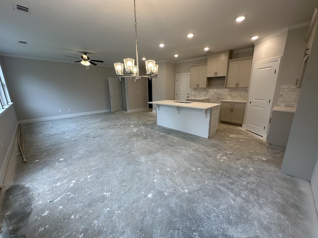 kitchen featuring visible vents, tasteful backsplash, a center island, and crown molding