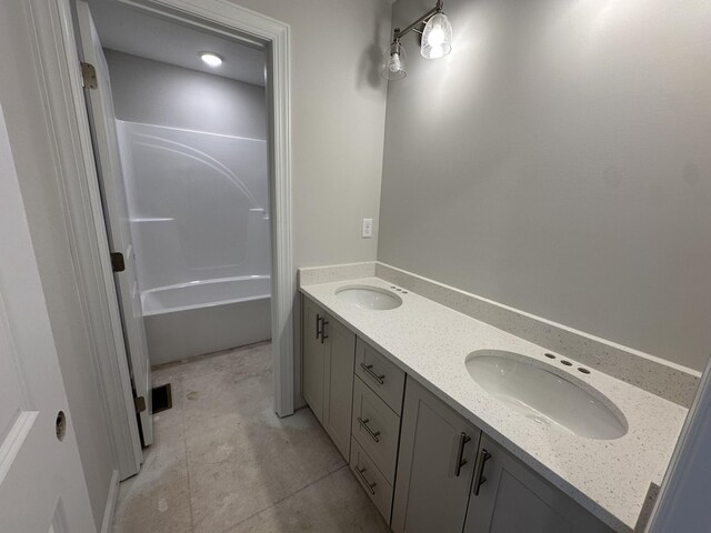 bathroom with tile patterned flooring, double vanity, visible vents, and a sink