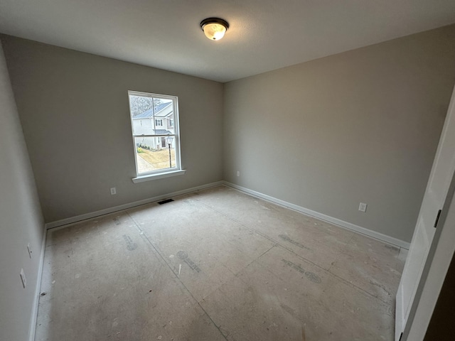 unfurnished room with visible vents and baseboards