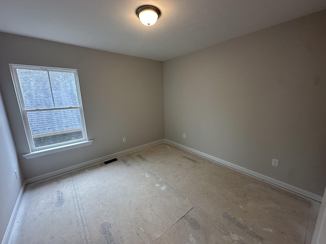 empty room featuring baseboards