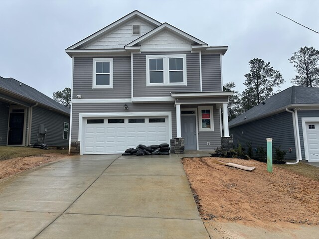 view of front of house with a front yard and a garage